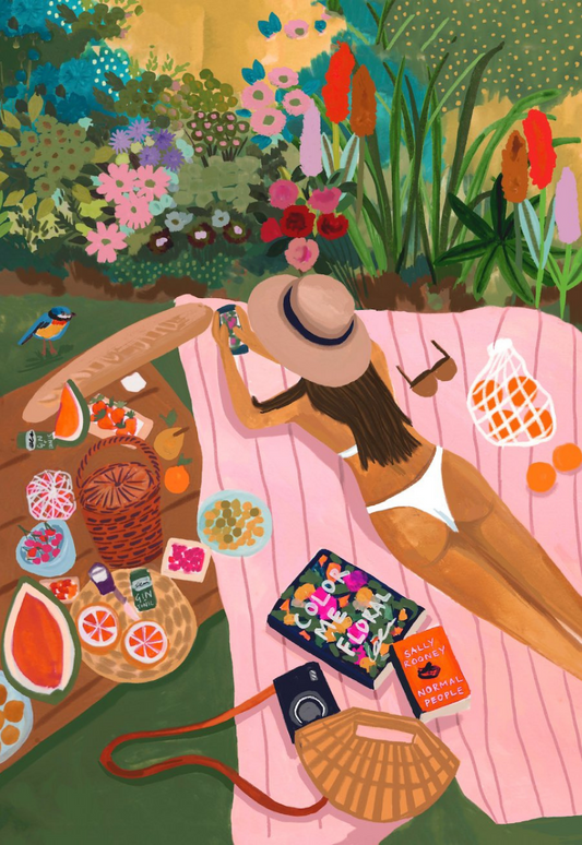 Woman relaxes on a pink picnic blanket in a lush garden, surrounded by colorful flowers, snacks, and books in a vibrant illustration. 
